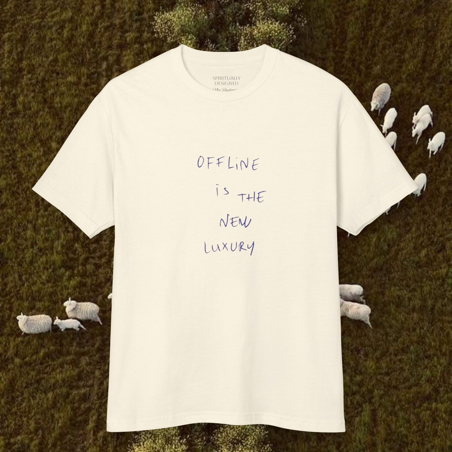 white cotton t-shirt with quote 'offline is the new luxury' raw minimalist t-shirt unisex style on a natural background landscape with sheeps trend 2026 tee