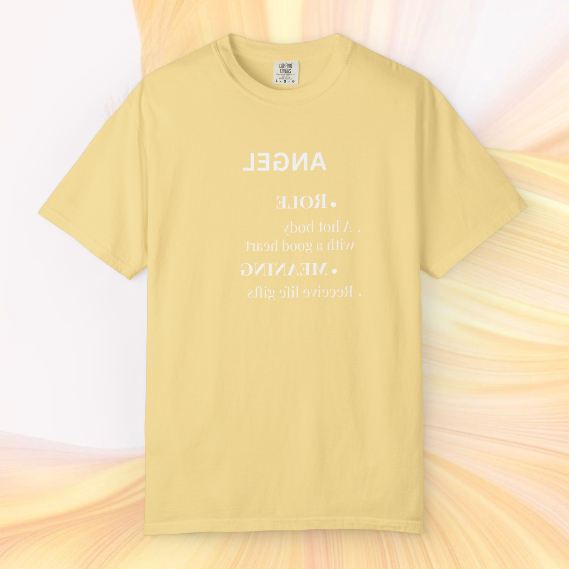 soft yellow t-shirt 100% cotton tee with the graphic written in reverse mirrored 'angel' signification text in white on a light yellow white ethereal background spiritually designed clothing line fashion 2026