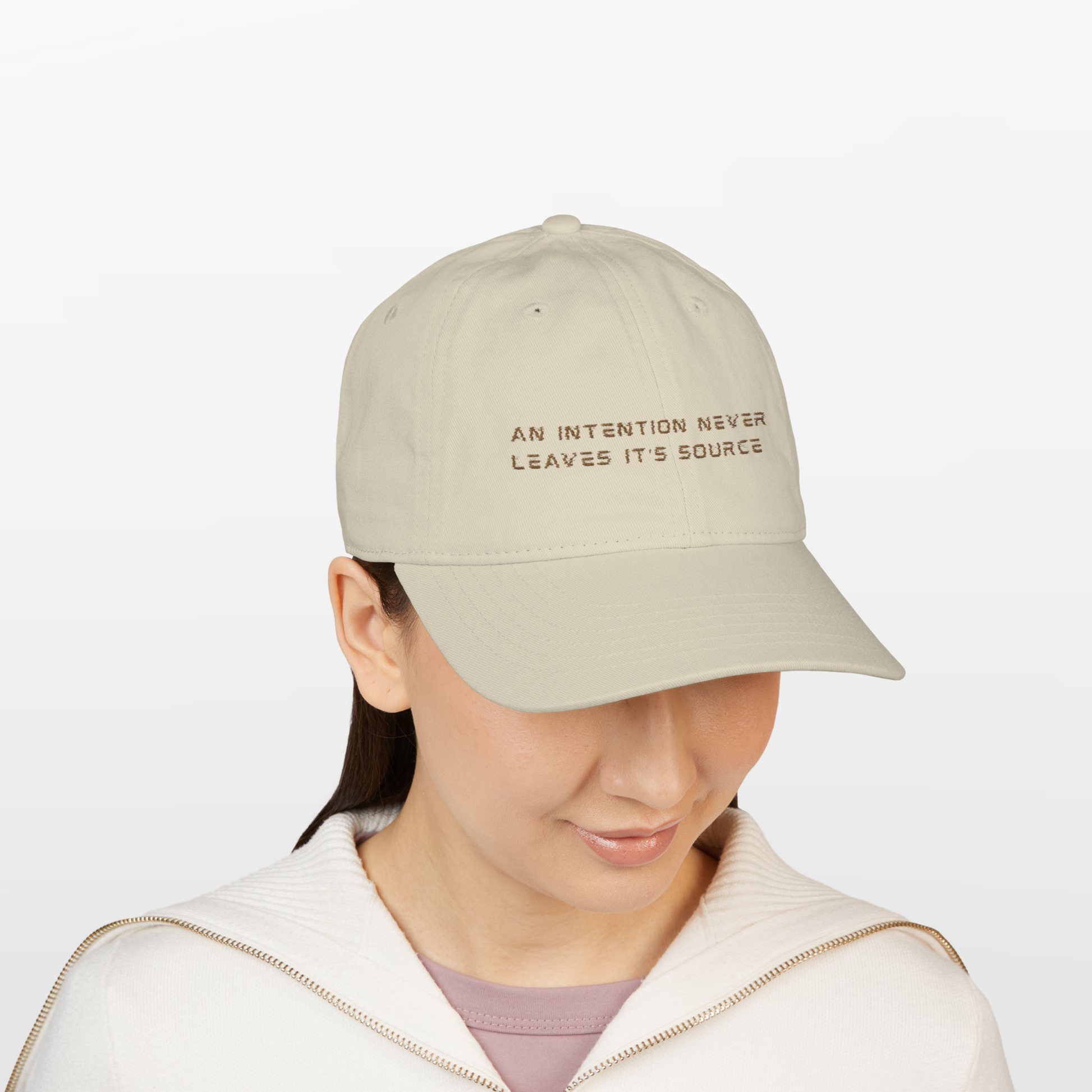 crown chakra protection baseball cap, spiritually designed by neo revelation this baseball unisex beige cap wore by brunette model on a white background protect the crown chakra from negative energies, spiritual attacks, mental interferences, fatigue