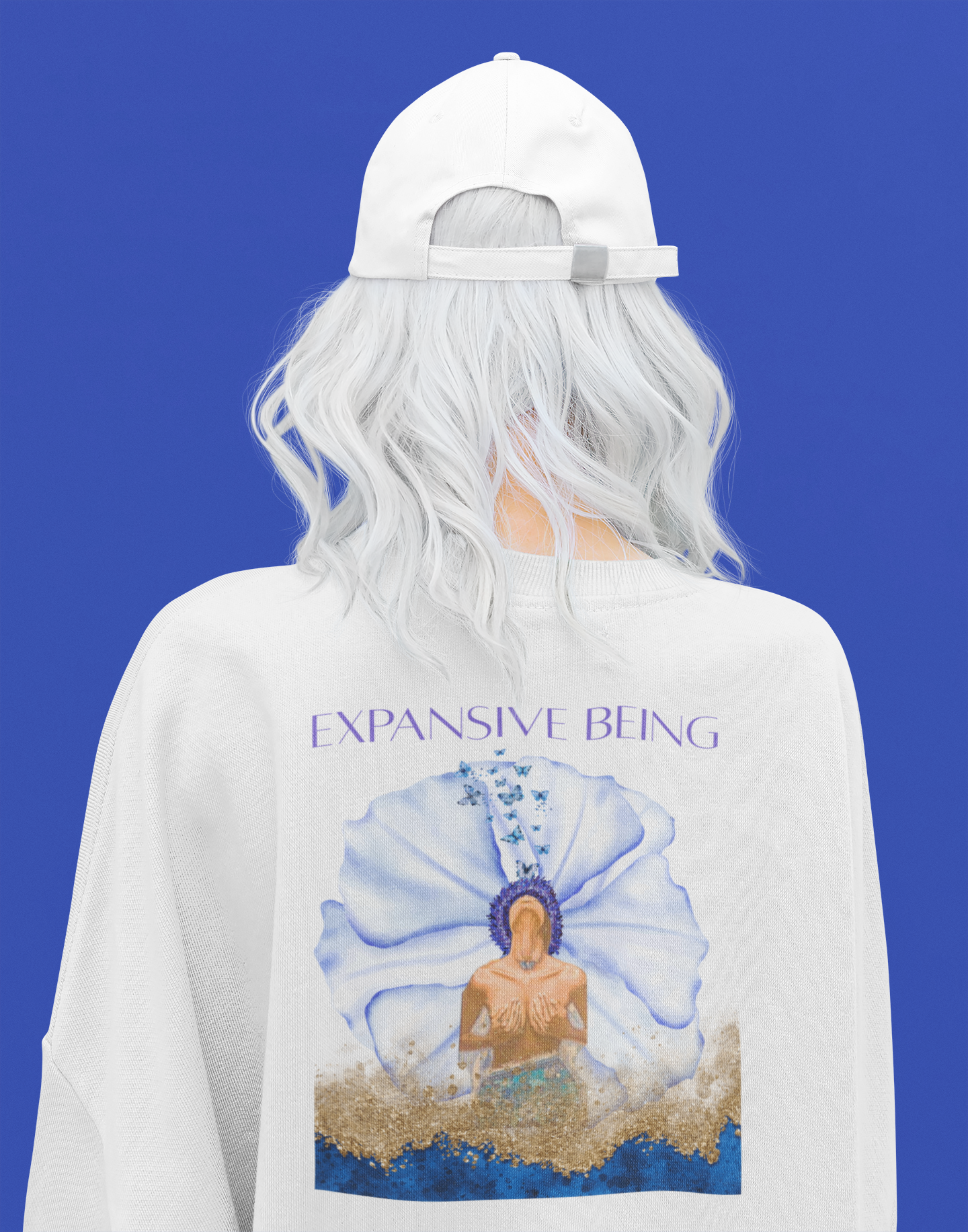 model standing with a white hat and white shirt with the design of blue flower and gold shades on a blue plain background high vibrational shirt spiritually designed for Neo Revelation brand innovative concept spiritual 