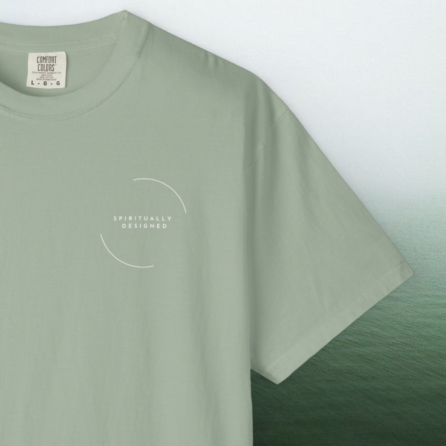 spiritually designed t-shirt printed graphic on green white gradiant background confort colors necklabel close up 