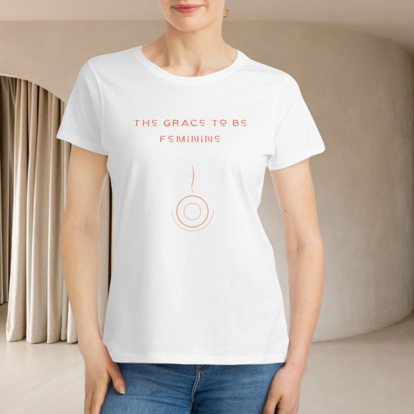 european model presenting a white  organic cotton t-shirt for women she is in interior minimalist beige we don't see her face only the high body and jean pants she is smiling 