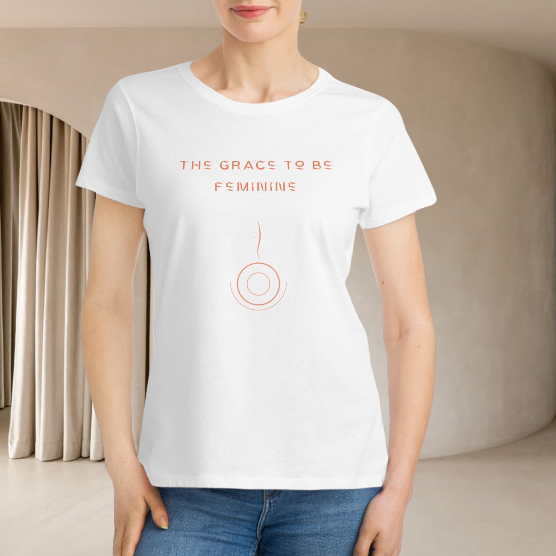 european model presenting a white  organic cotton t-shirt for women she is in interior minimalist beige we don't see her face only the high body and jean pants she is smiling 
