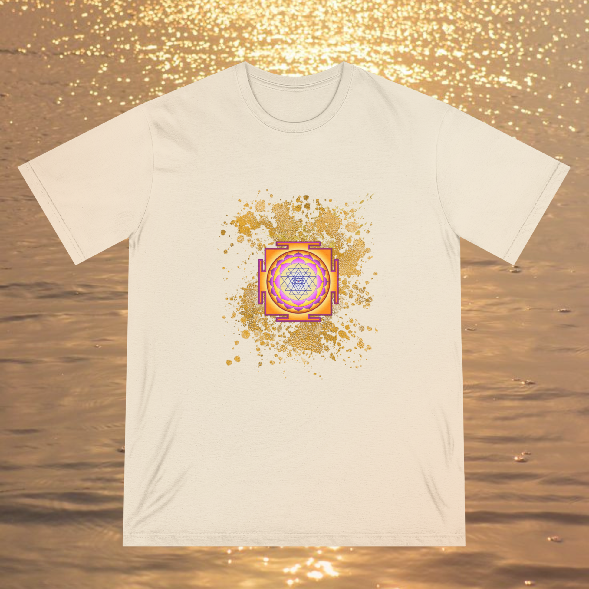 Spiritual clothing energy infused intentional fashion to wear, cream color tee with gold color explosion graphic with the sri yantra graphic on a ocean sunset background, high vibrational clothing for unisex minimalist fashionista