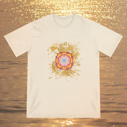 Spiritual clothing energy infused intentional fashion to wear, cream color tee with gold color explosion graphic with the sri yantra graphic on a ocean sunset background, high vibrational clothing for unisex minimalist fashionista