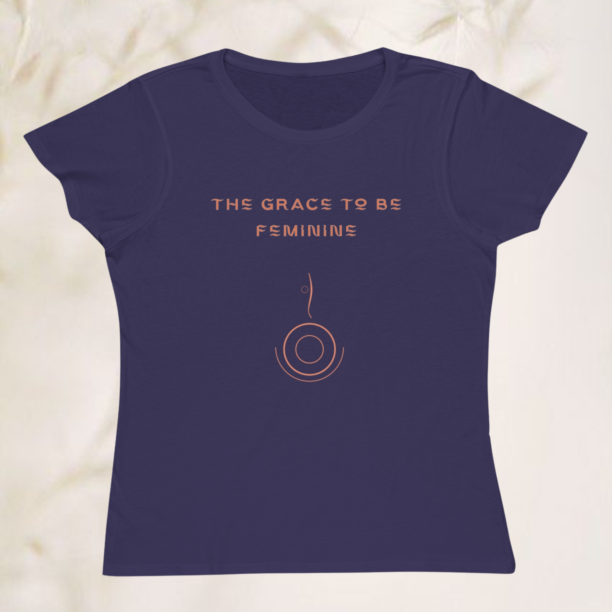 'the grace to be feminine' printed on purple t-shirt for women in orange color with a minimalist symbol, the style is minimalist reffined for 30 to 70 years old women 
