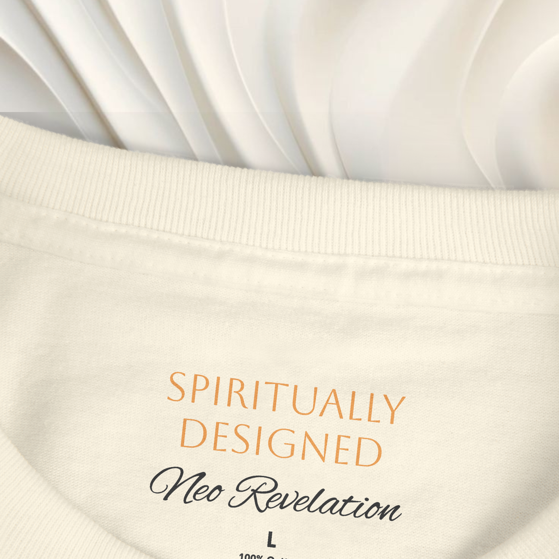 necklabel white t-shirt cotton with the words ' spiritually designed' printed on it and 'neo revelation' on a white ethereal background